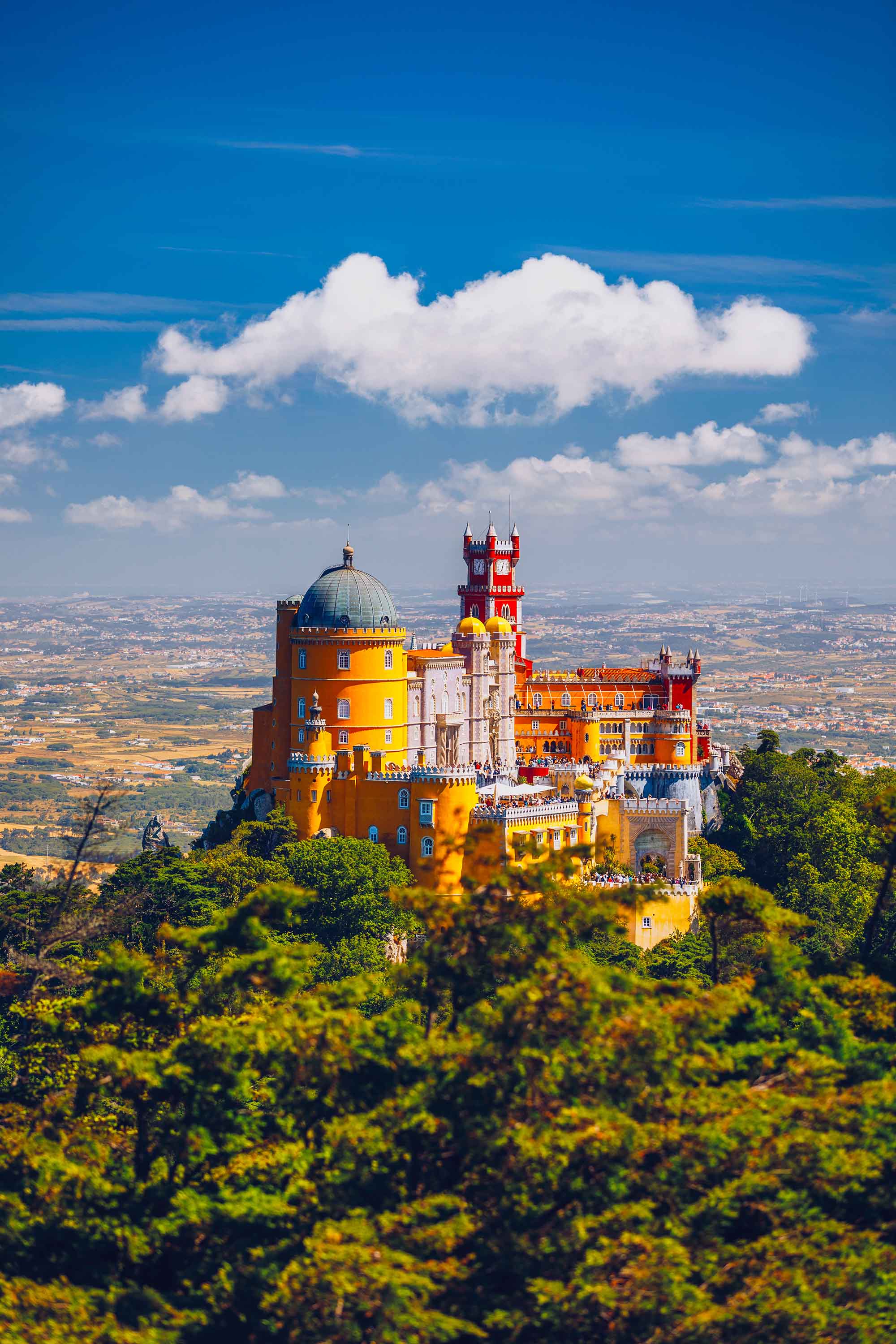 Famous historic Pena palace part of cultural site of Sintra against sunset sky in Portugal