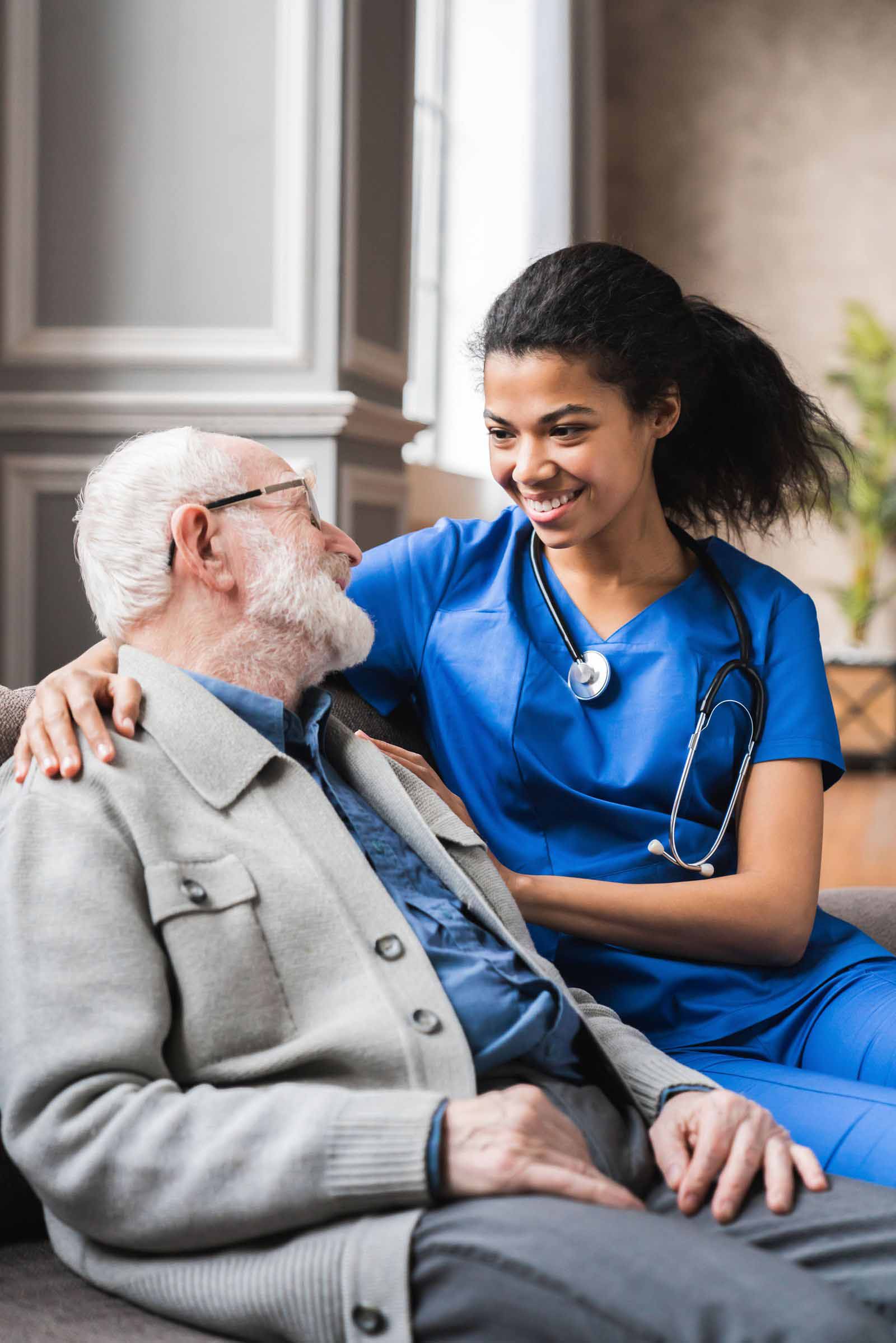 Vertical photo of helpful young female doctor nurse consulting old elderly man