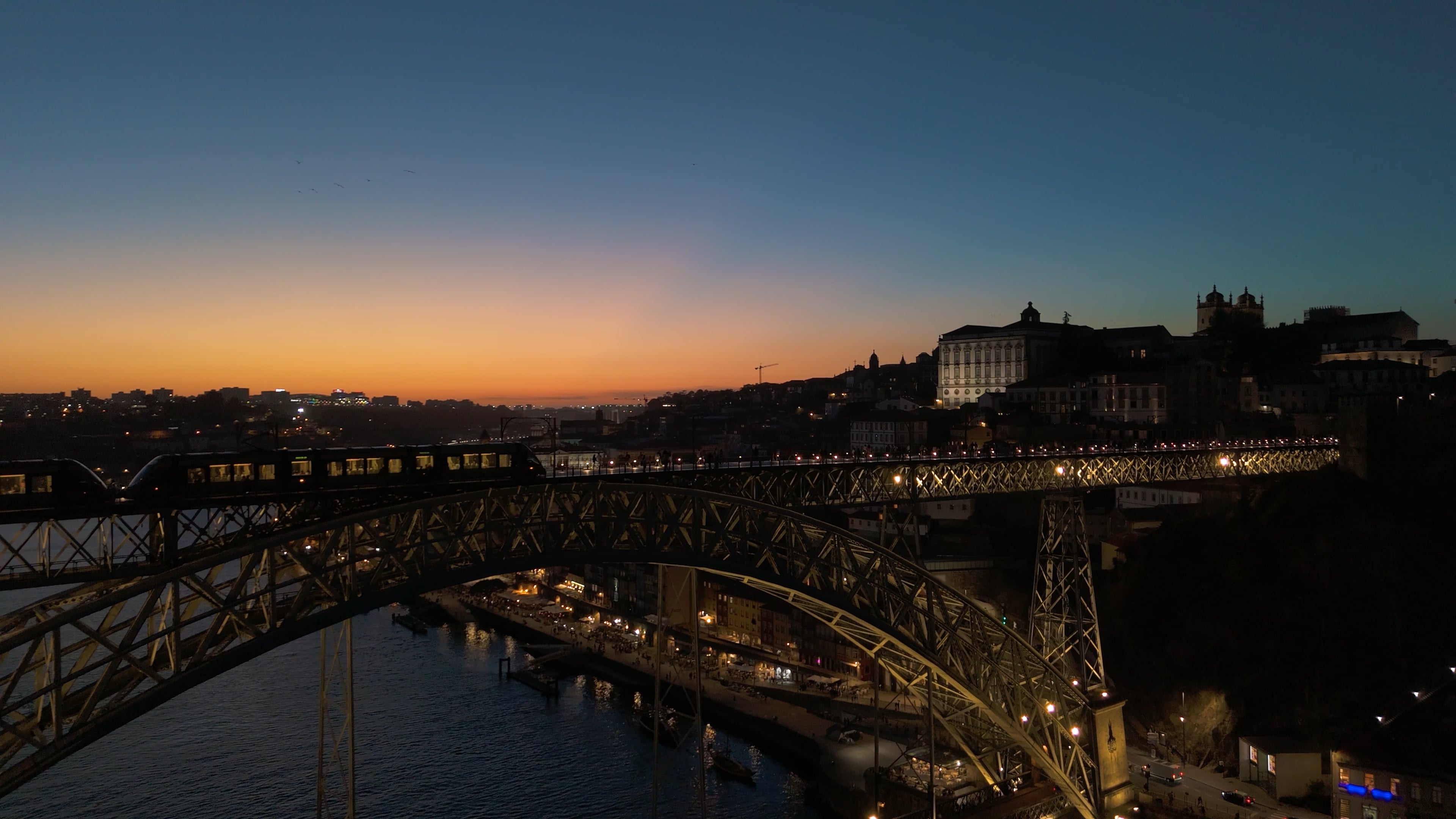 Sunrise over Porto and a train going over the bridge