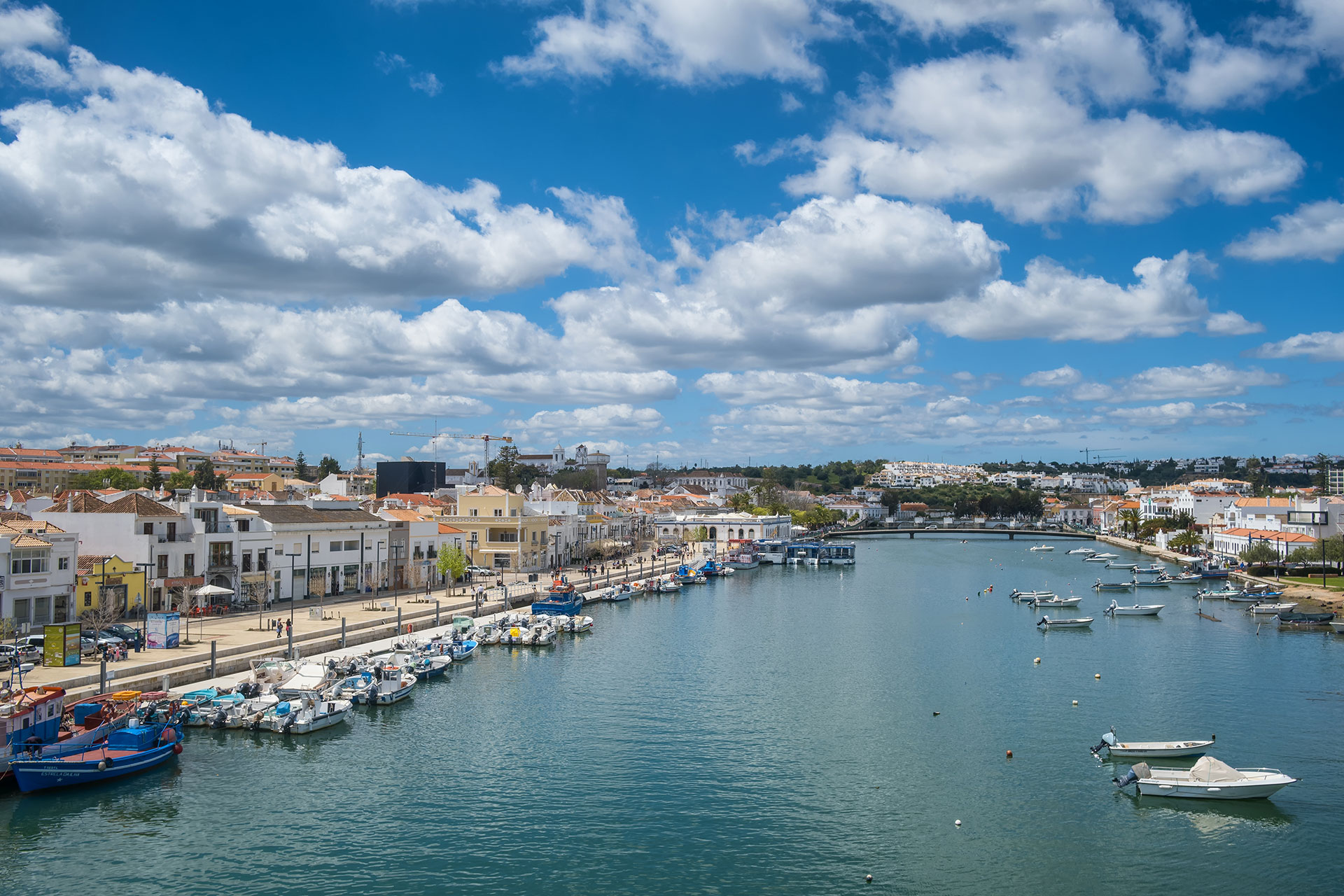 Boats moored alongside the beautiful Gilao riverfront in Tavira old town