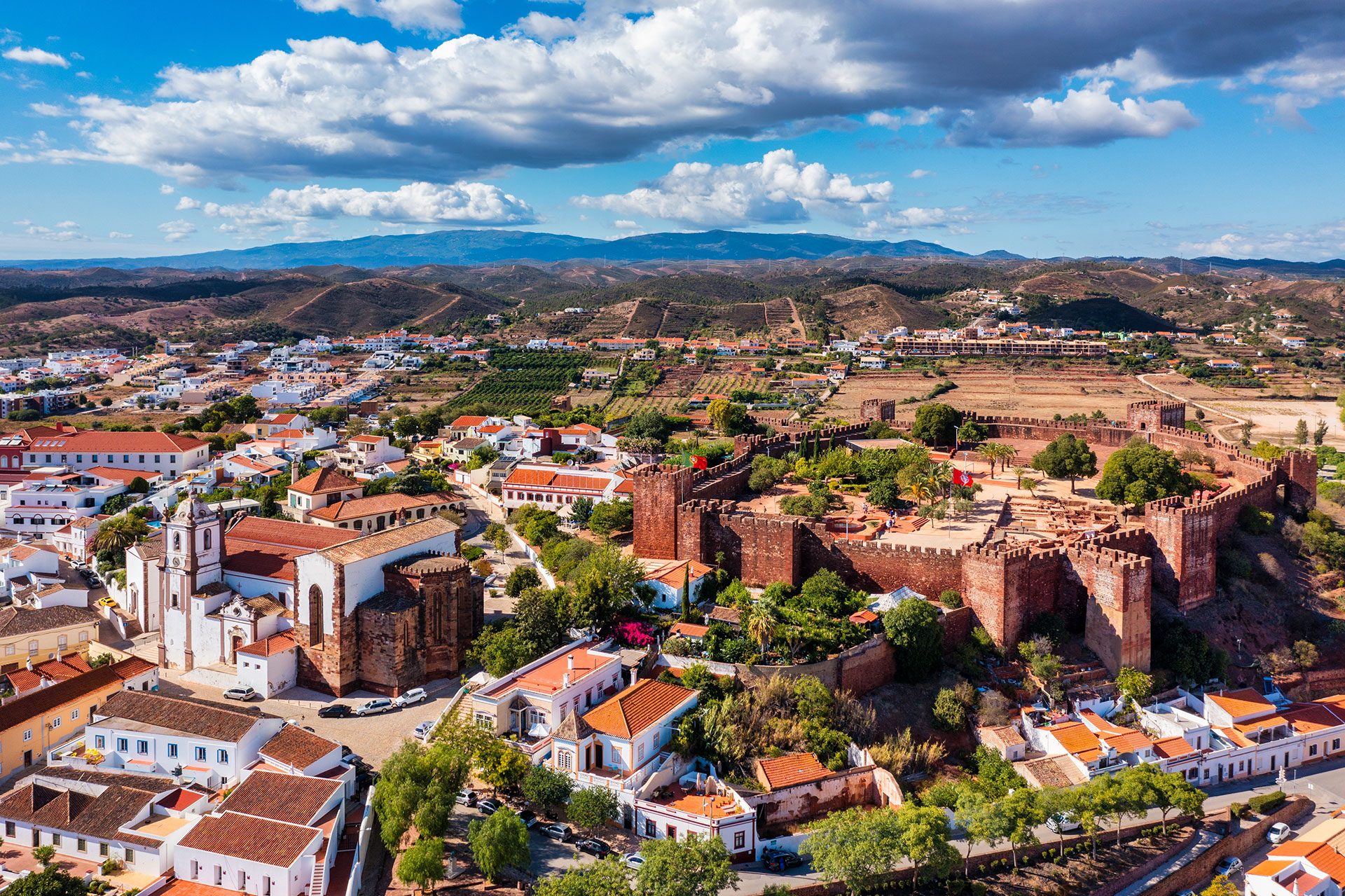 View of Silves town buildings and cathedral with wall surrounding its famous Medieval castle