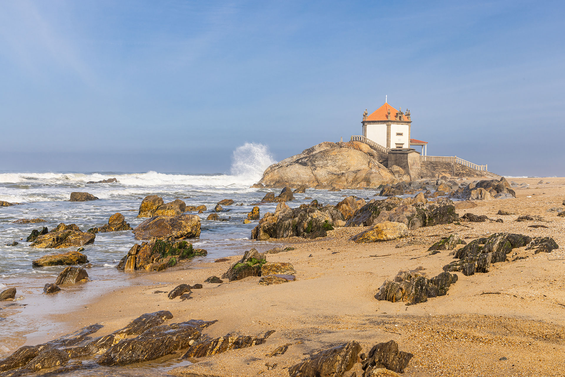 Arcozelo's Chapel by the sea with dramatic waves
