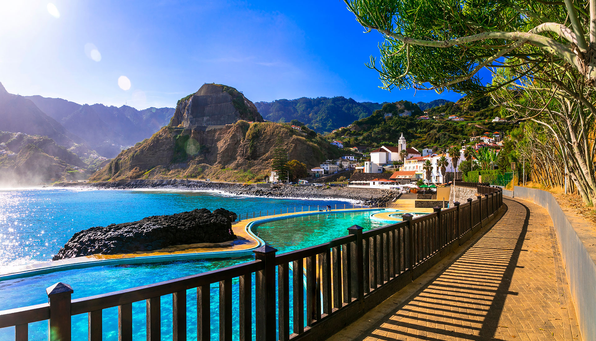 View of rocky coast and Atlantic ocean with waves on a beautiful sunny day in Porto da Cruz