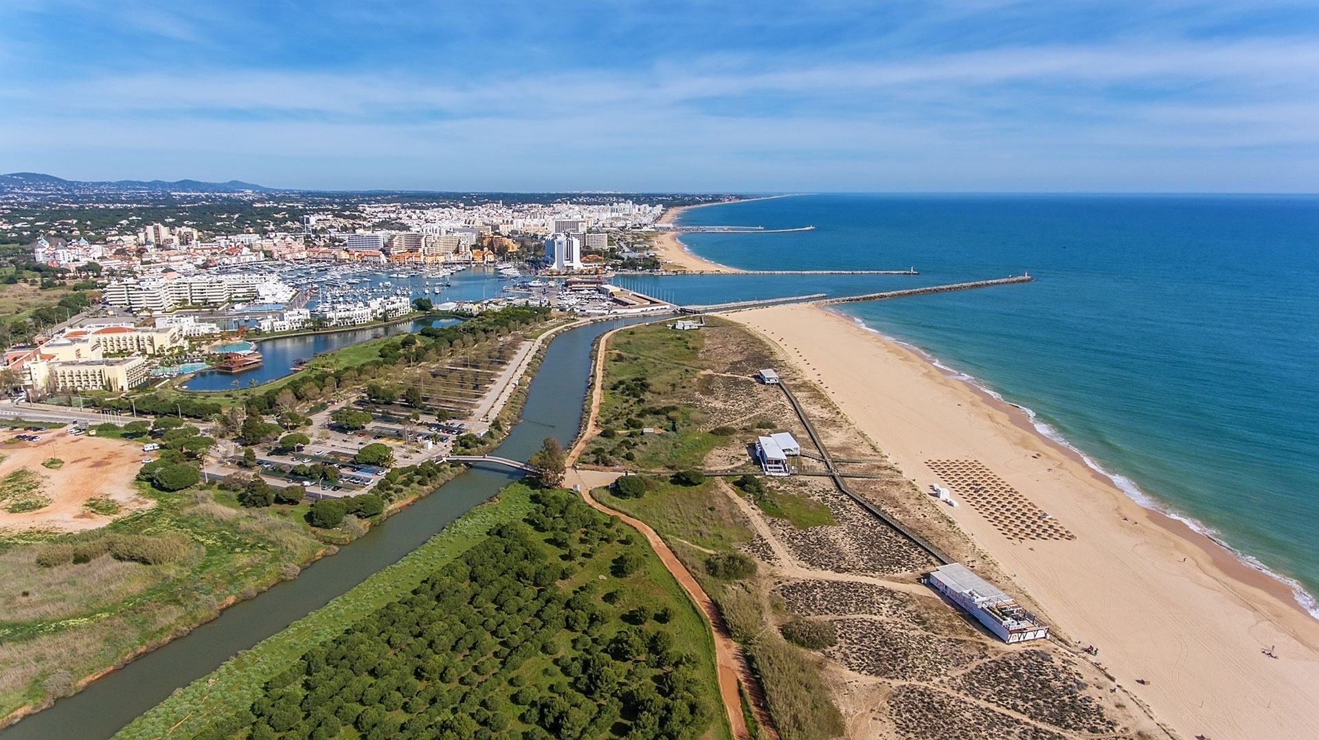 Panoramic view of Vilamoura’s beach and river mouth leading to the popular marina