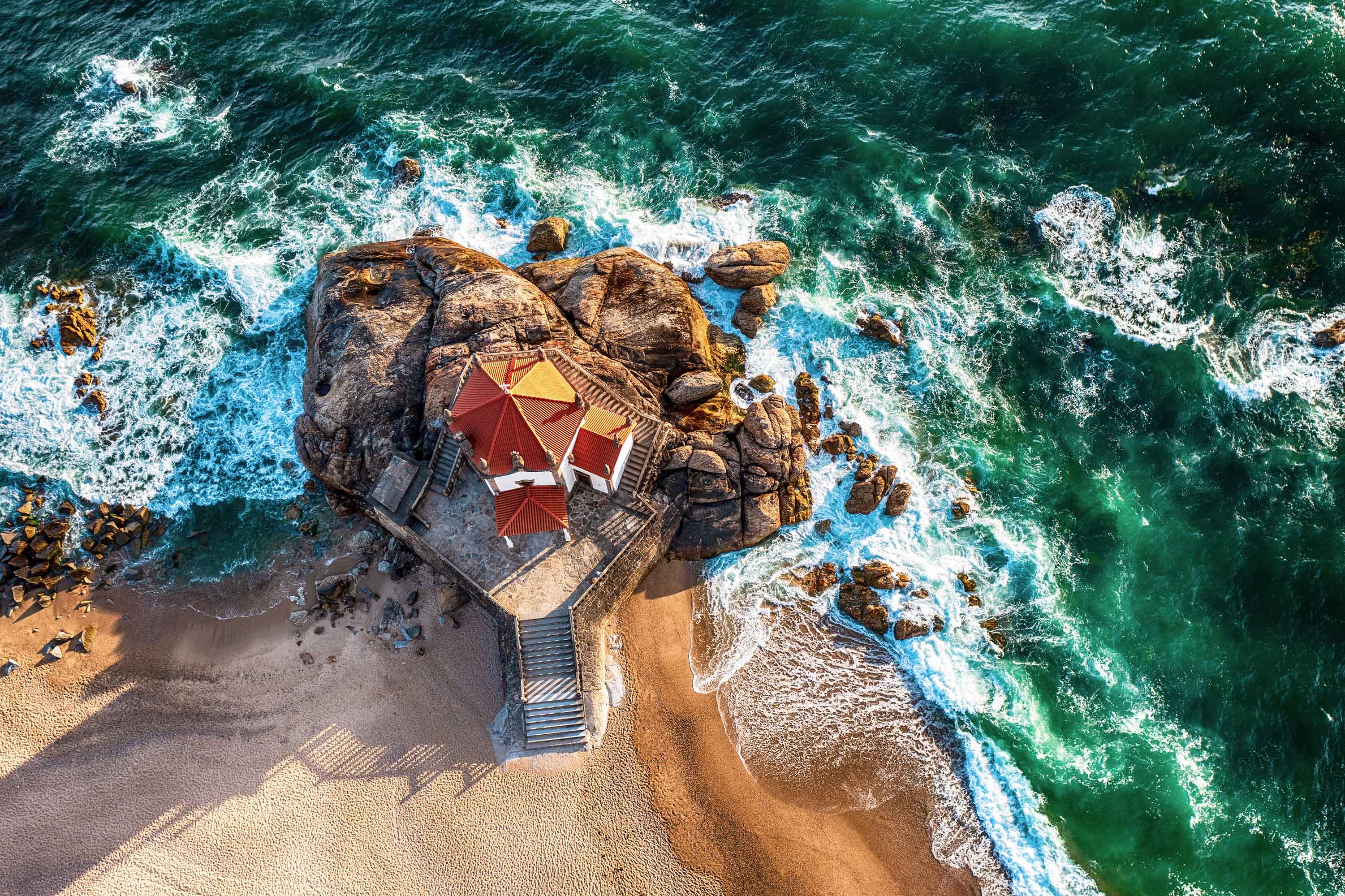 Aerial view of the Chapel Senhor da Pedra on Miramar beach, in Portugal