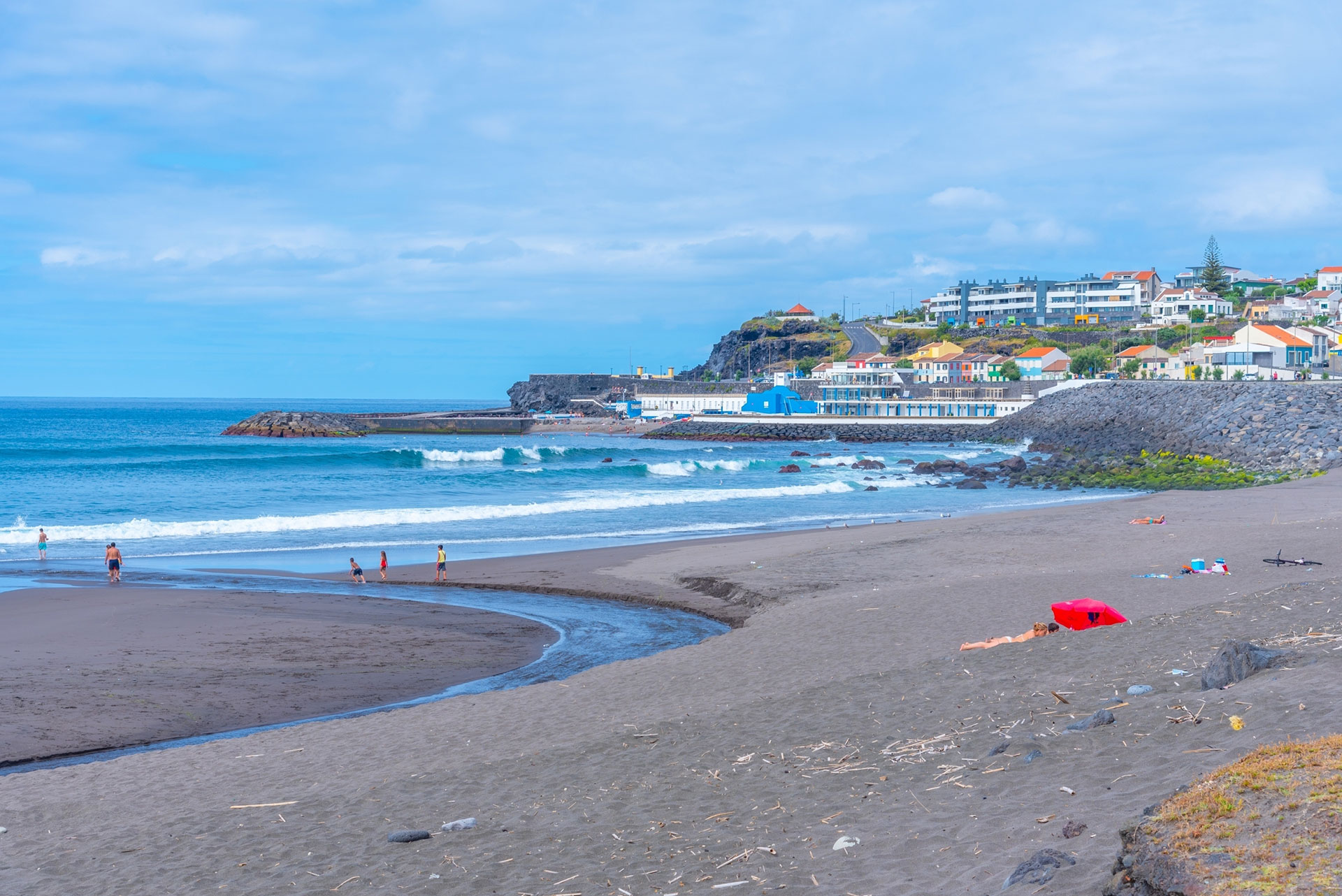 People are strolling on beach at Ribeira Grande at Sao Miguel island 