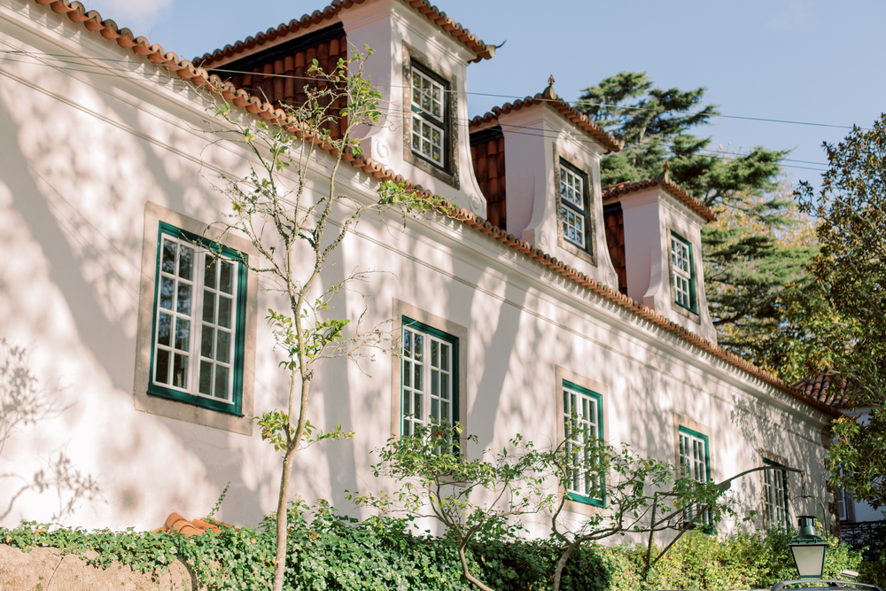 Traditional Portuguese manor house with green windows and dormer roof accents