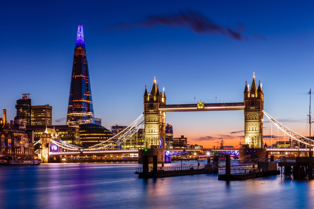 Tower Bridge and The Shard illuminated at dusk over the River Thames in London