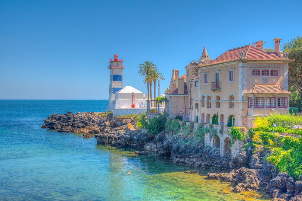 Santa Marta Lighthouse and Museum in Cascais, Portugal, against a bright blue sky and sea