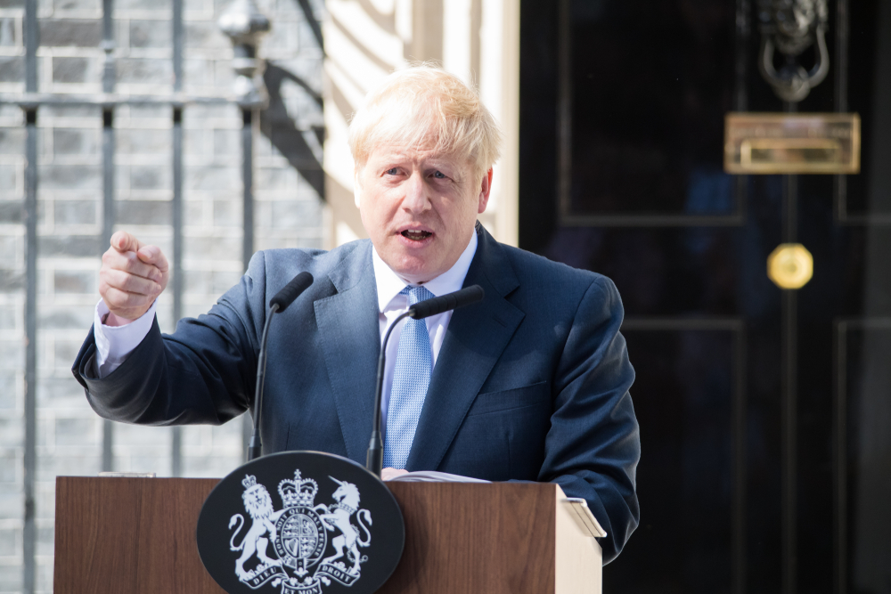 Boris Johnson giving a speech at a podium outside 10 Downing Street in London