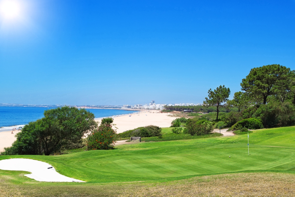 Scenic golf course view with green fairways leading to the beautiful beach at Quinta do Lago