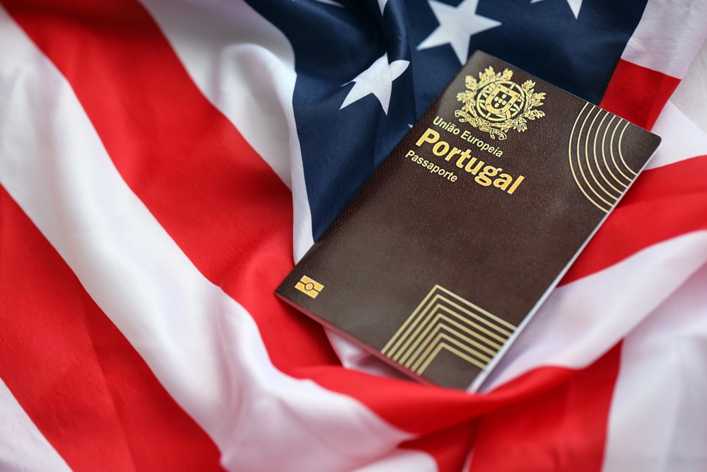 Portuguese passport on top of a USA flag