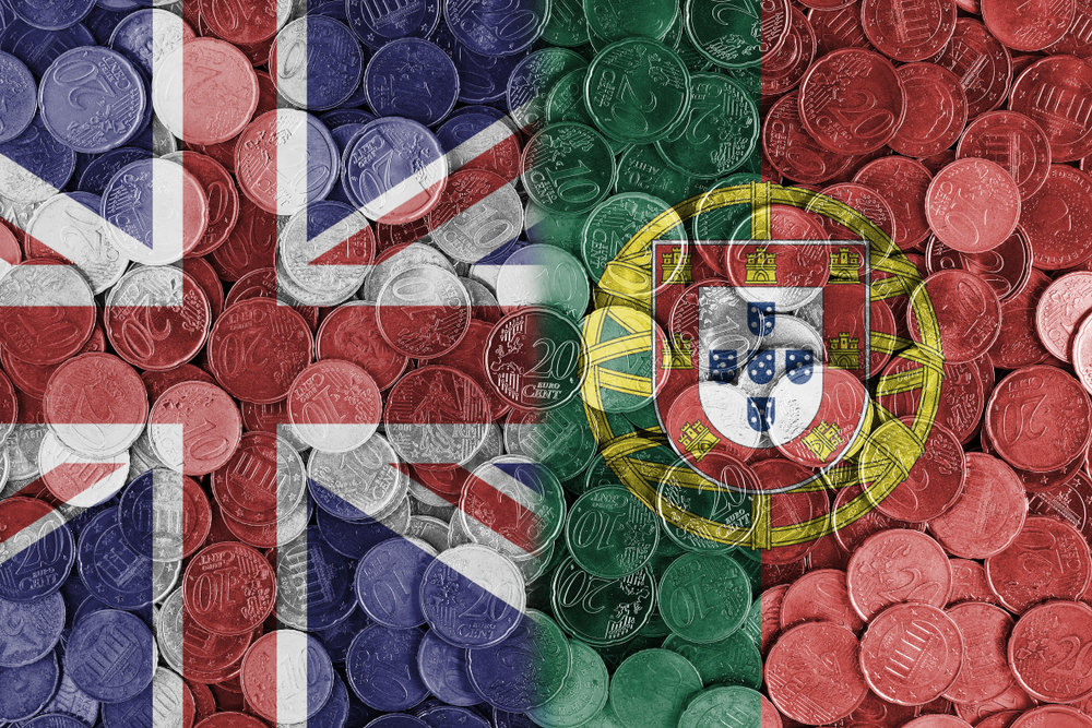 Overhead view of Euro coins overlaid with the national flags of the UK and Portugal