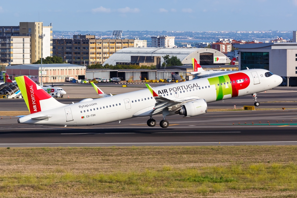 TAP Air Portugal Airbus plane taking off into clear skies at Lisbon airport