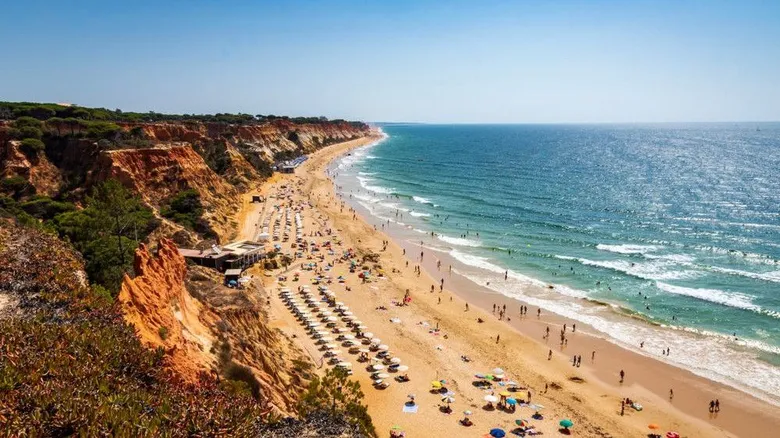 Red cliffs and miles of golden sands at Falésia Beach in Portugal's Algarve region