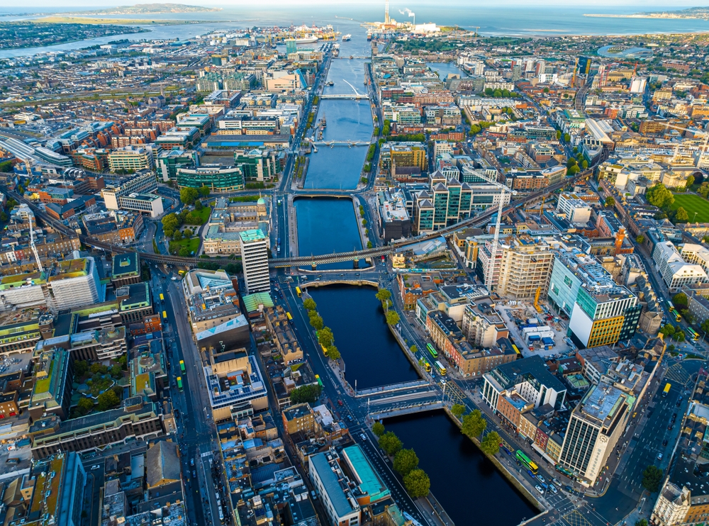 Cityscape of Dublin featuring the River Liffey and several bridges under a clear blue sky