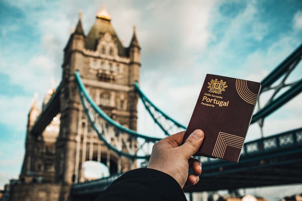 A man holding a Portugal passport in London