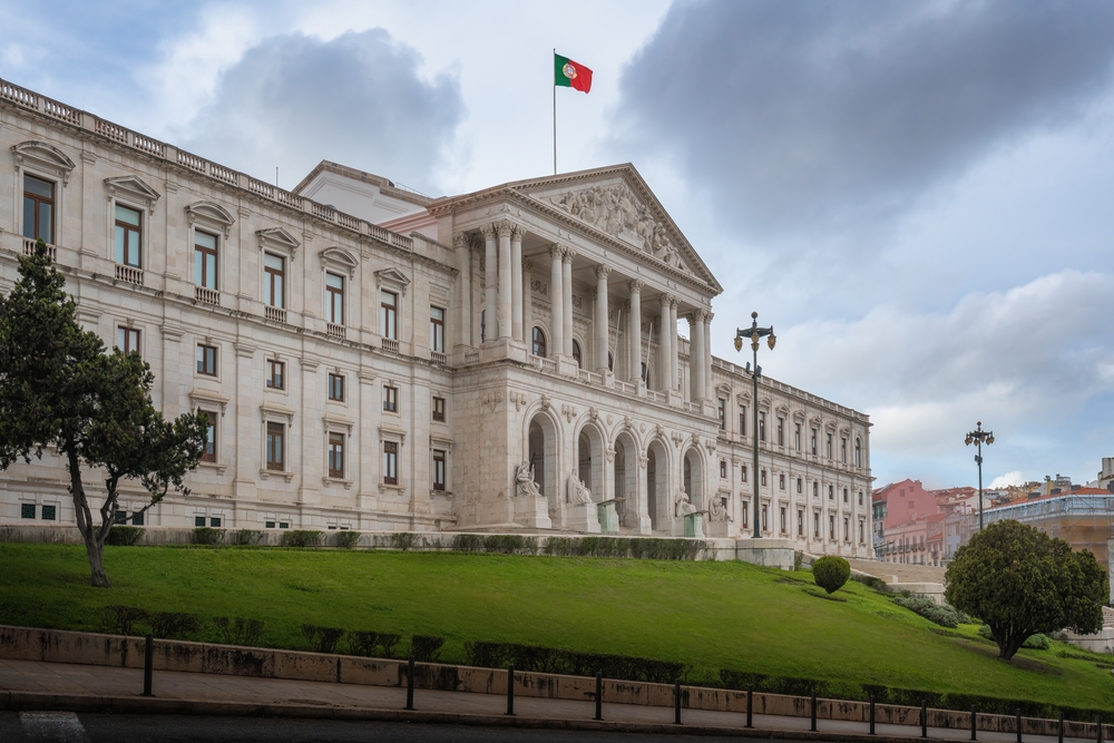 Lisbon São Bento Palace architectural facade seen from the street showing columns and grassy hill