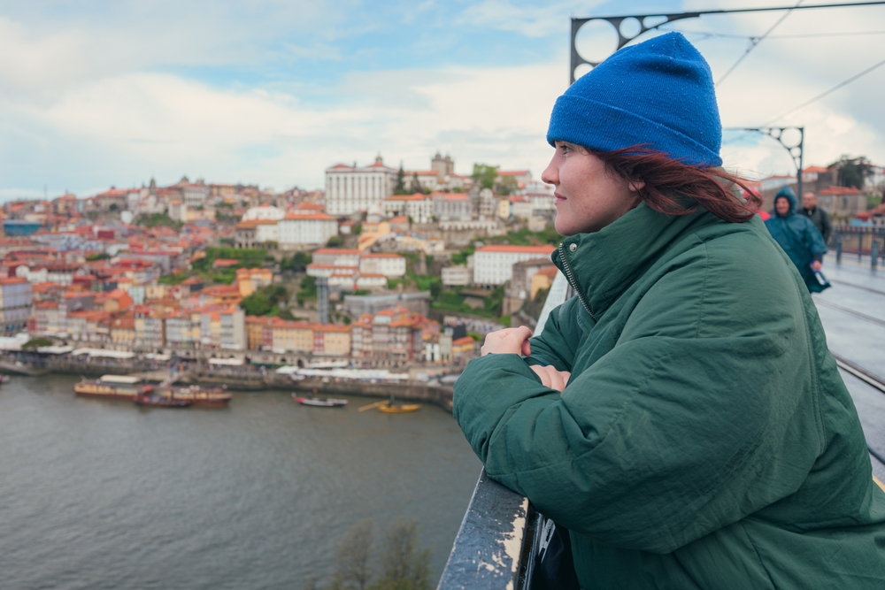Woman overlooking the picturesque Douro River and colorful cityscape of Porto