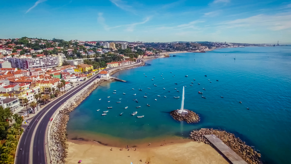 Aerial view of Paço de Arcos in Oeiras with a beach, boats, and a water fountain