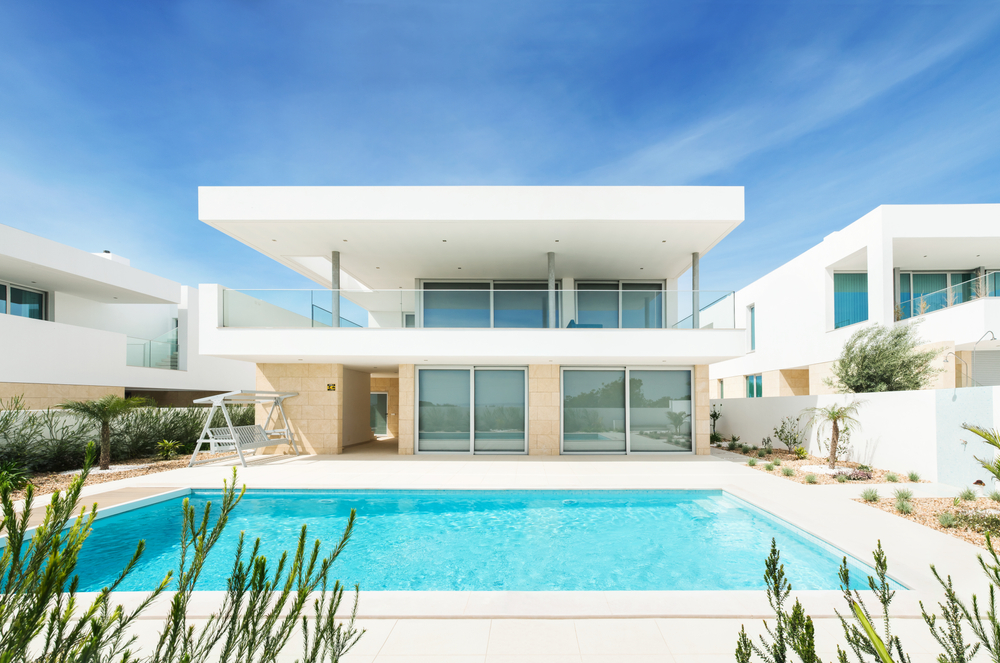 Modern design luxury white house with swimming pool, terrace and balcony