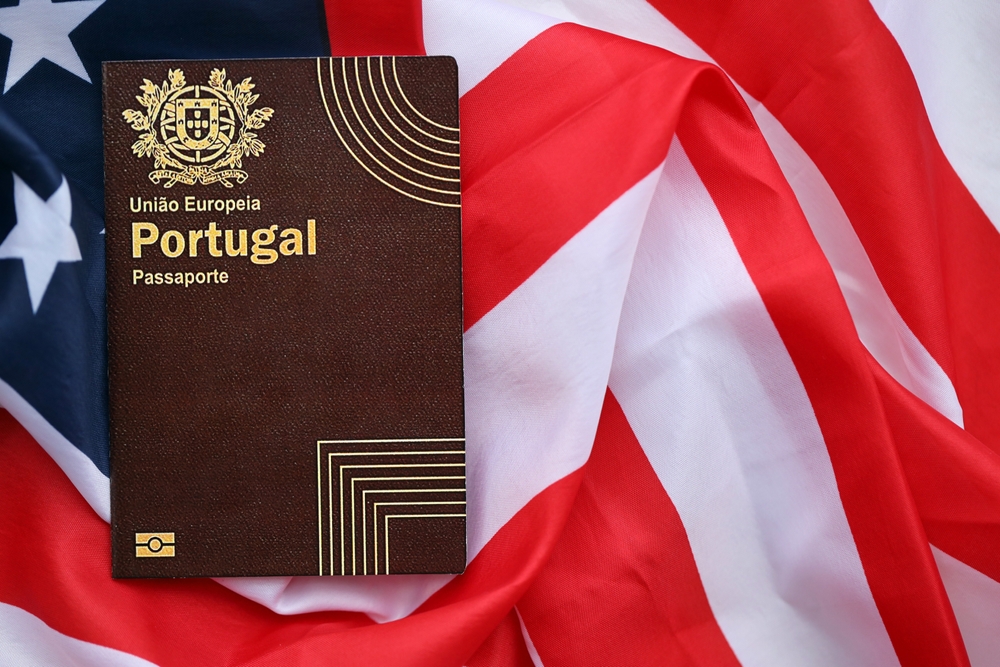 Portugal passport placed on top of USA flag