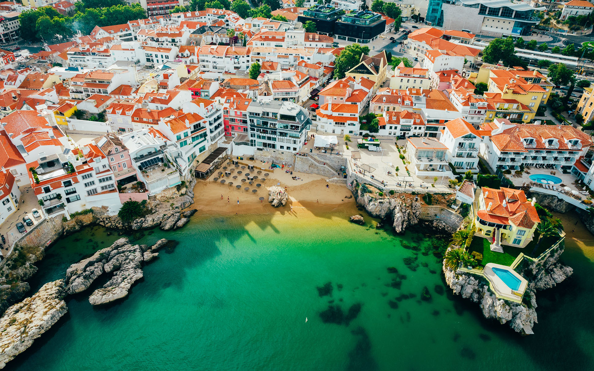 Drone aerial view of Praia da Rainha and historic city centre of Cascais in Portugal