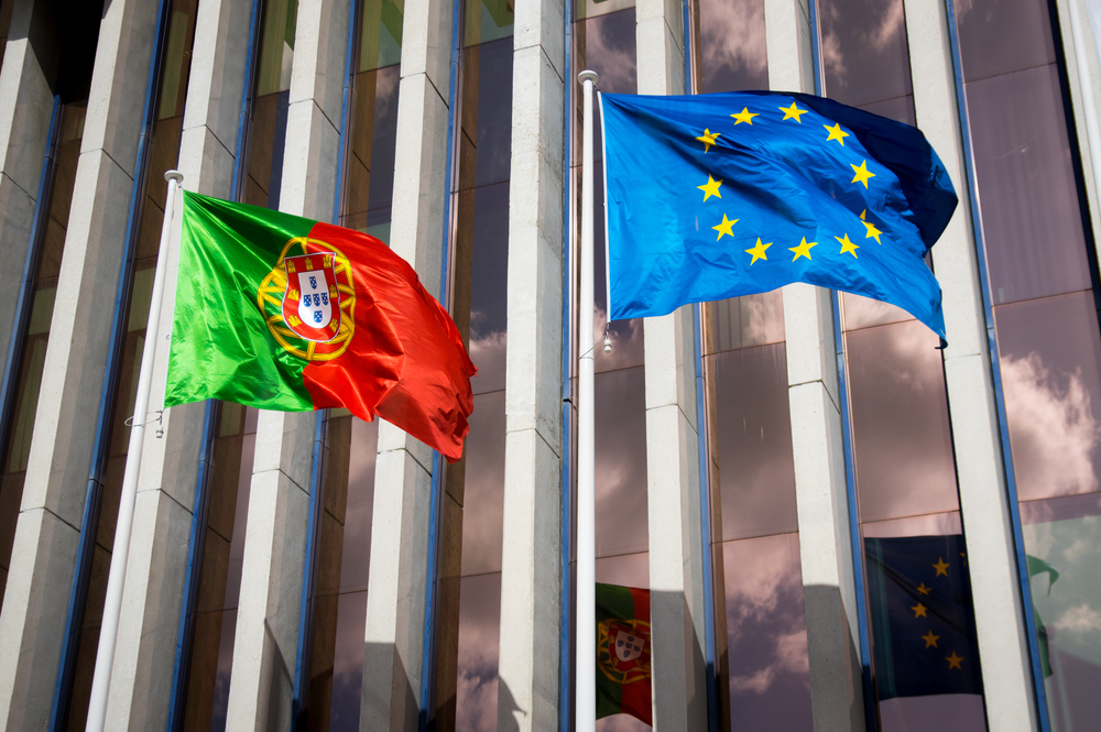 Portugal flag and EU flag outside modern building