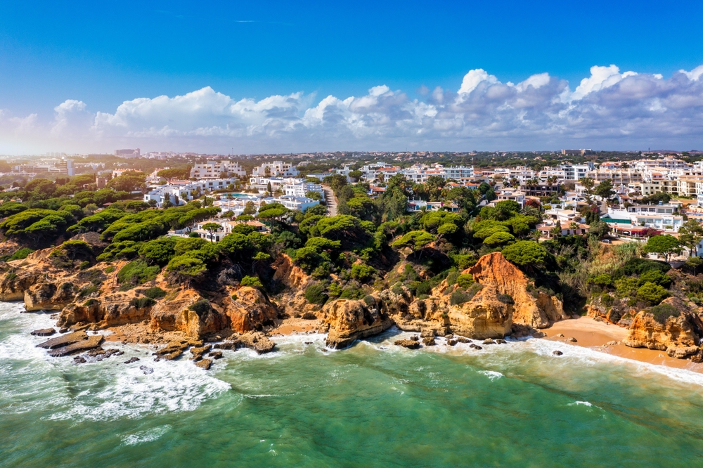Aerial view of resort town and cliffs in the Algarve