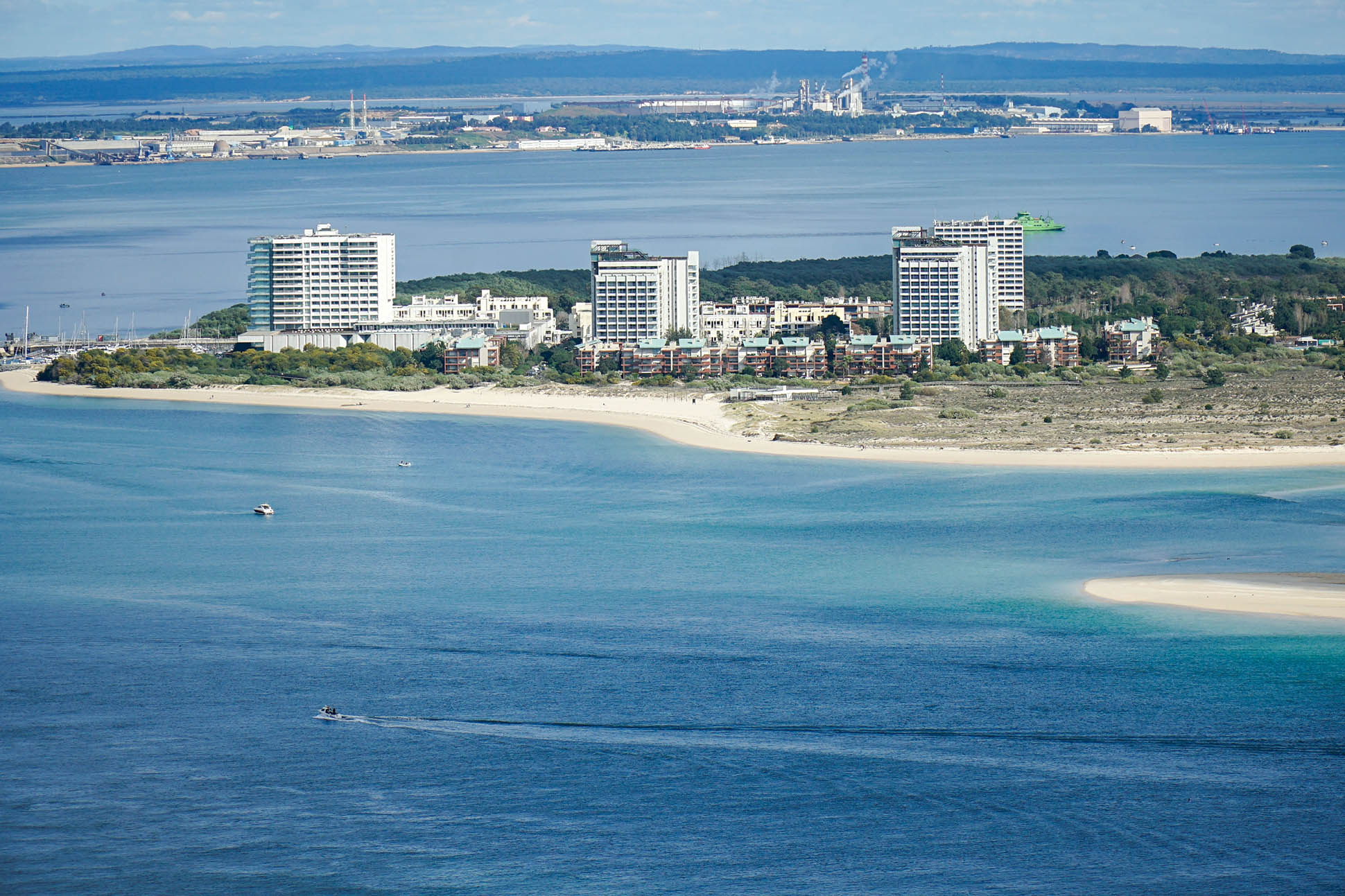 Aerial view of Troia Peninsula, Portugal, with beach resorts, blue water and industrial bay