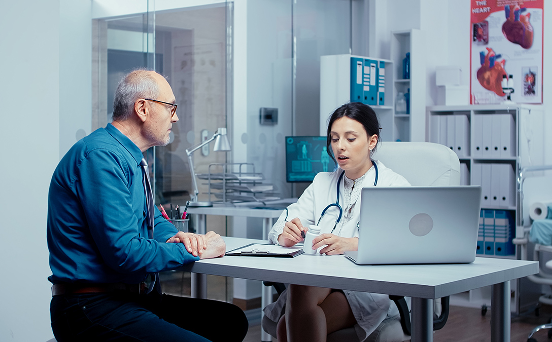  Gemini said Female doctor in a lab coat discusses medication with a senior patient in a medical office