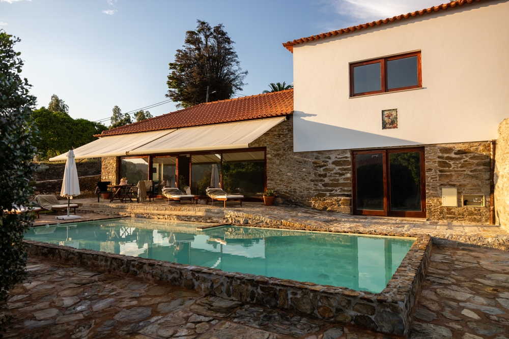 Rural modern villa in Portugal with swimming pool at sunset