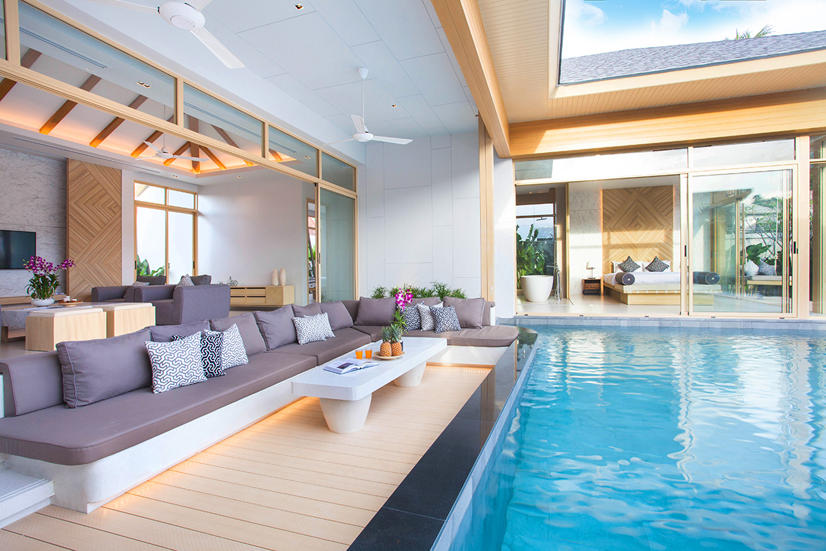 Luxury modern villa with a sunken outdoor lounge area and a private turquoise swimming pool