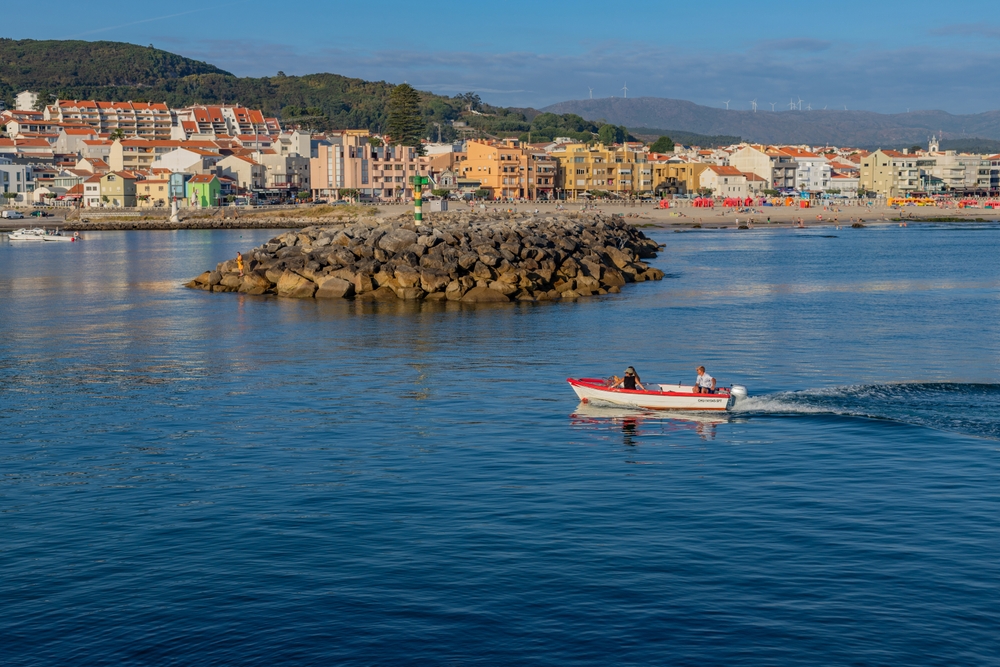 Fishing boat at sea near village in Portugal