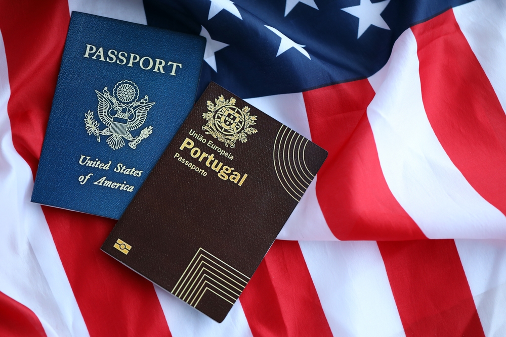 Portugal passport and US passport on USA flag