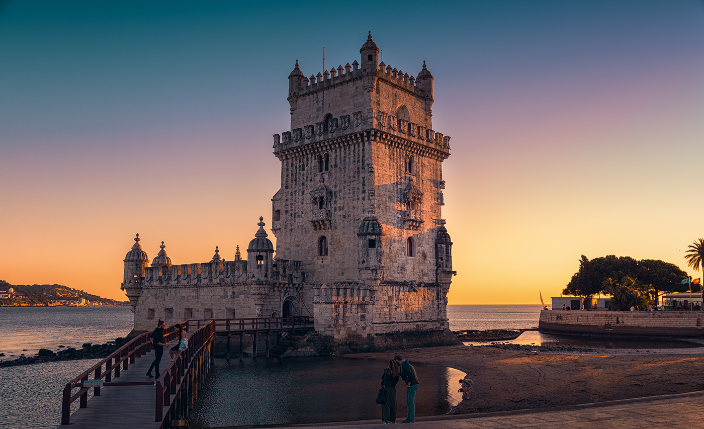 Torre de belem, a historical landmark in Lisbon, Portugal, is beautifully illuminated by the setting sun