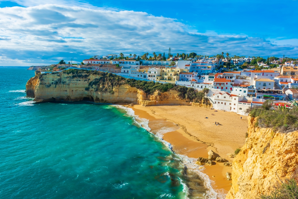 Sandy beach with coastal town in Portugal