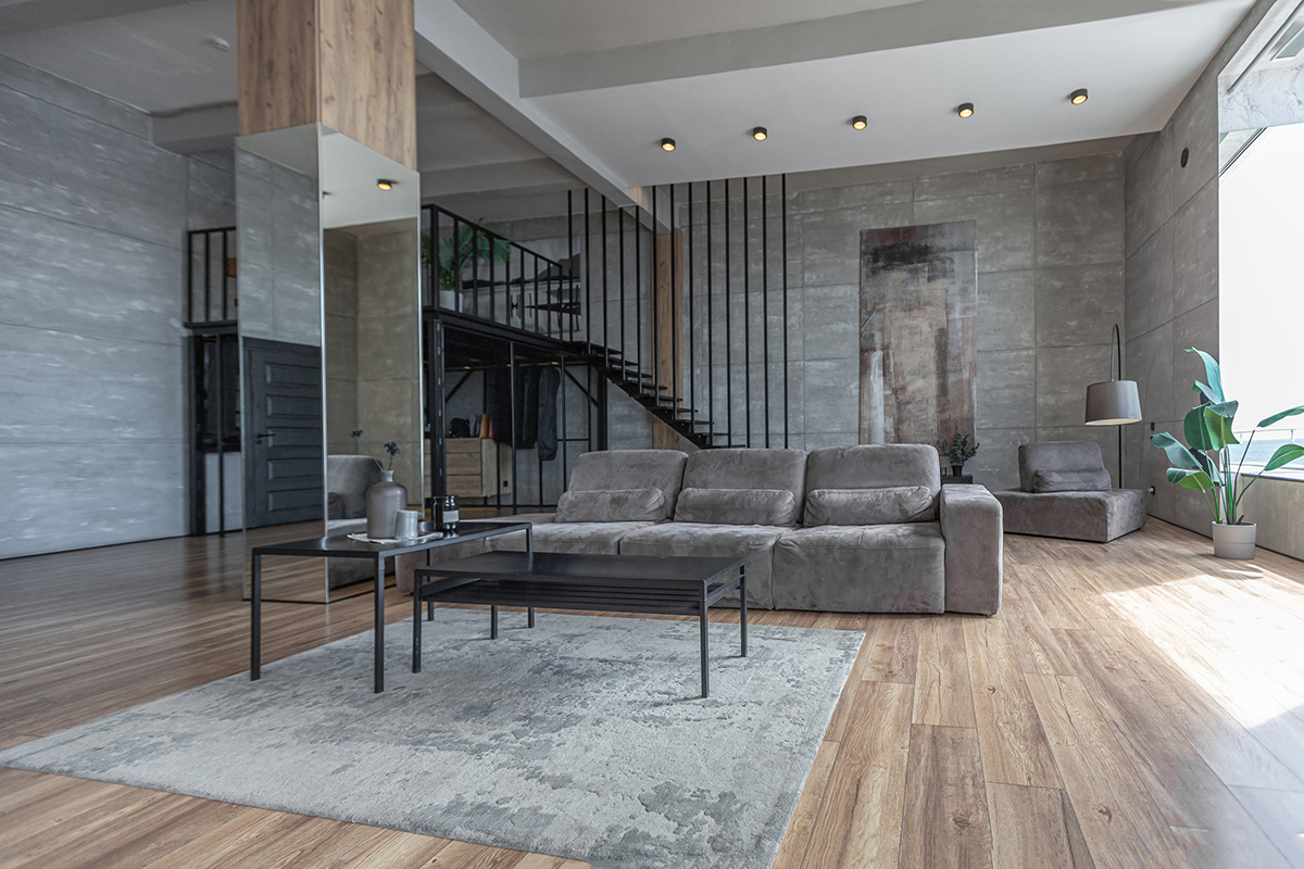 stylish minimalistic restrained modern interior of a two-storey apartment without people in the daytime in loft style in gray tones.