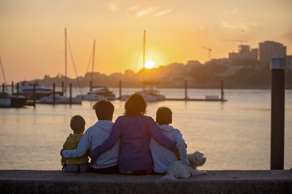 Family enjoying sunset at harbor in Portugal