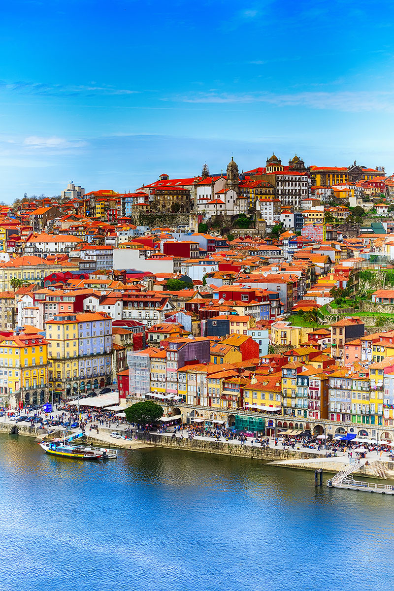 Porto, Portugal old town ribeira aerial promenade view with colorful houses, Douro river and boats