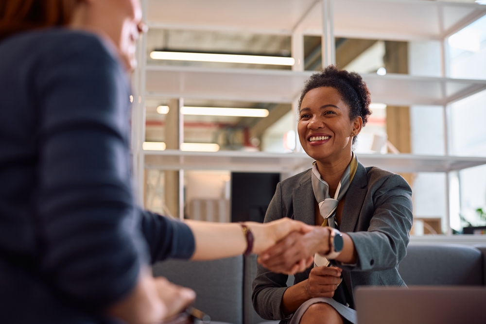 Bank manager shaking hands with new client