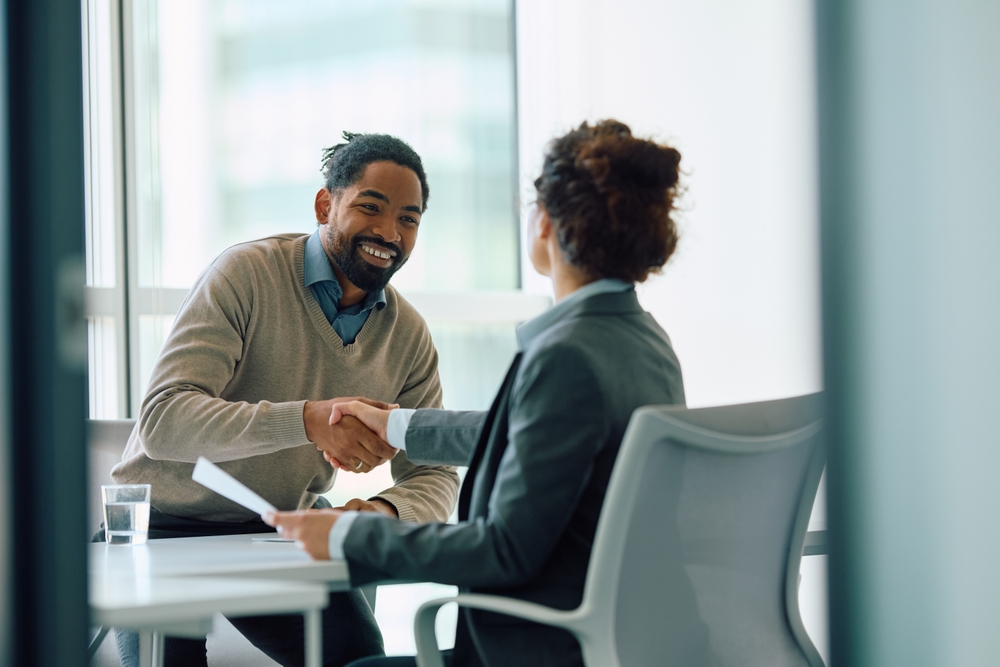 Man meeting with financial advisor modern office building