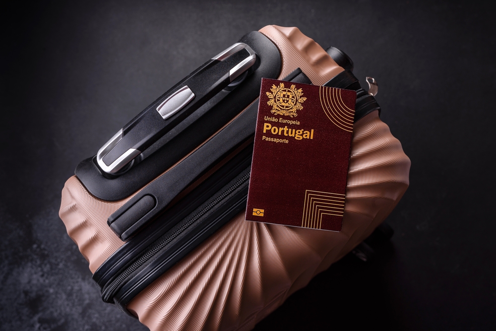 Portugal passport on top of suitcase, signifying freedom of EU passport