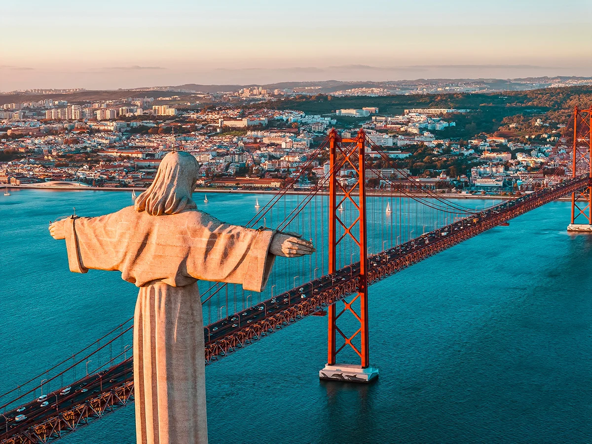 Christ the King statue overlooking 25 de Abril Bridge, Tagus River and the Lisbon skyline
