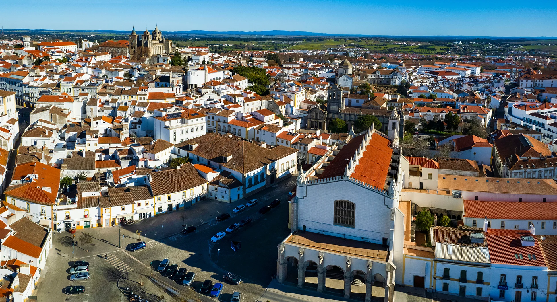 The prominent Church of Saint Francis stands above a town square filled with white houses