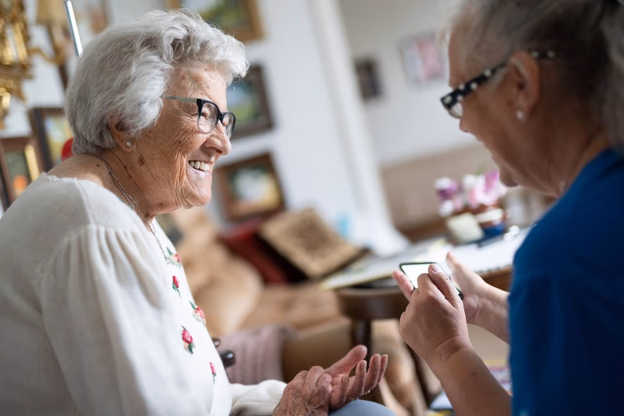 an elderly getting help with her phone
