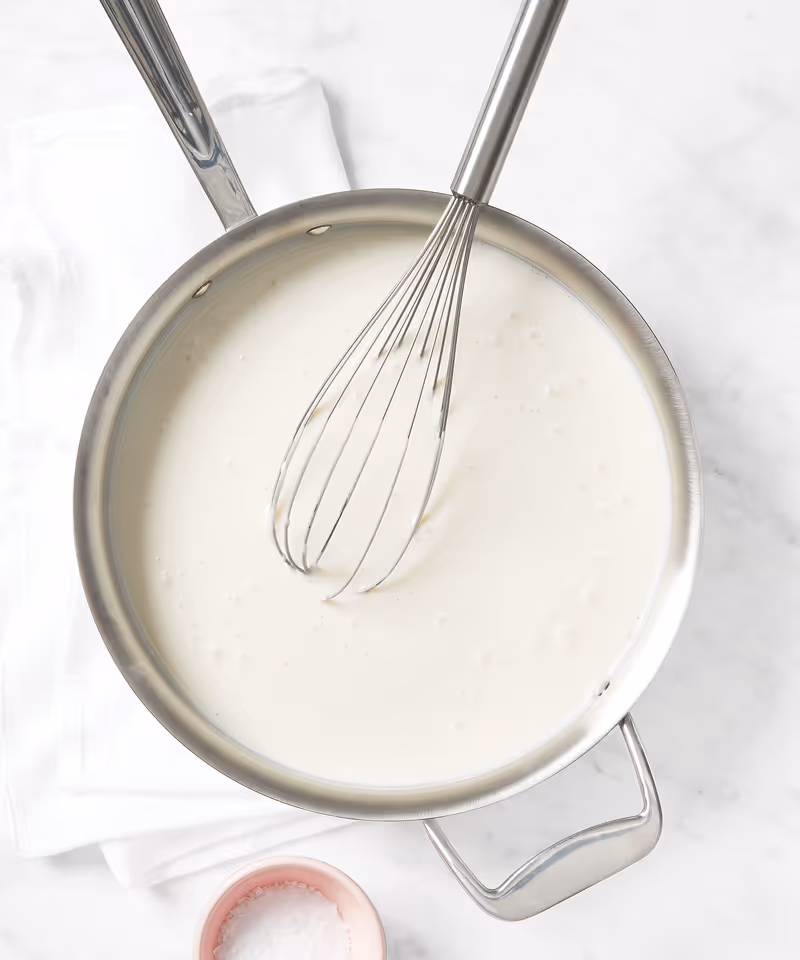 A liquid being mixed in a pan.