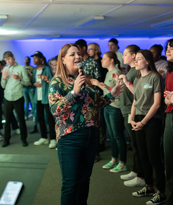 Pastor Kristin Hawes leading worship at River Youth