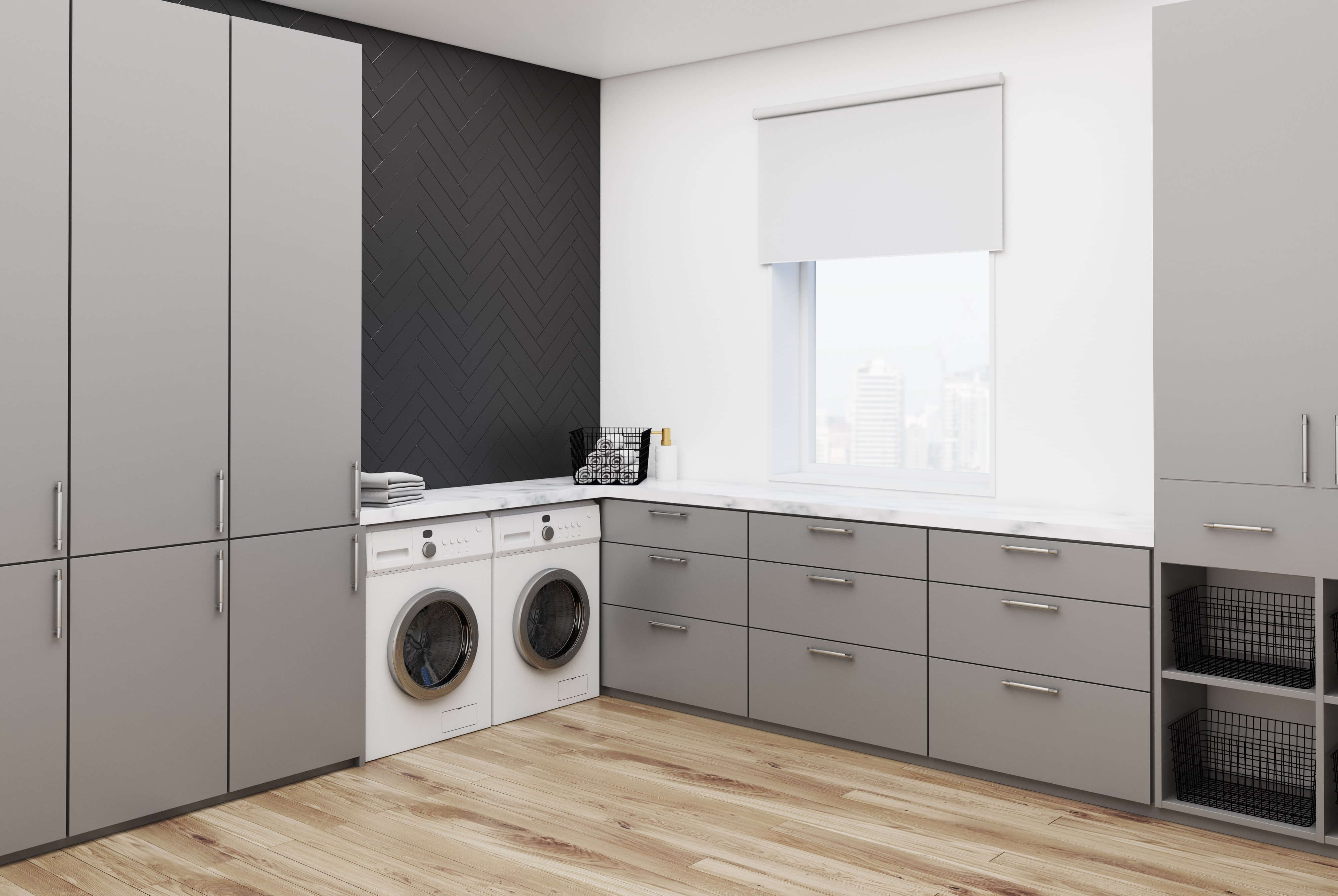 A custom laundry room that has white and gray colors.