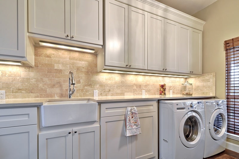 Custom dream Laundry room that has a sink and dryers